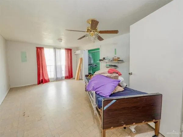 a bedroom with a bed a desk and chair