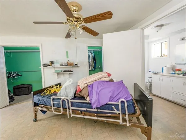 a bedroom with furniture and a ceiling fan