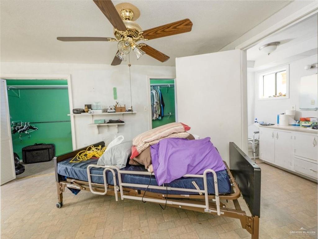 23067 Cragon Road Harlingen, TX 78552 - Photo 9 of 28 a bedroom with a bed a desk and chair