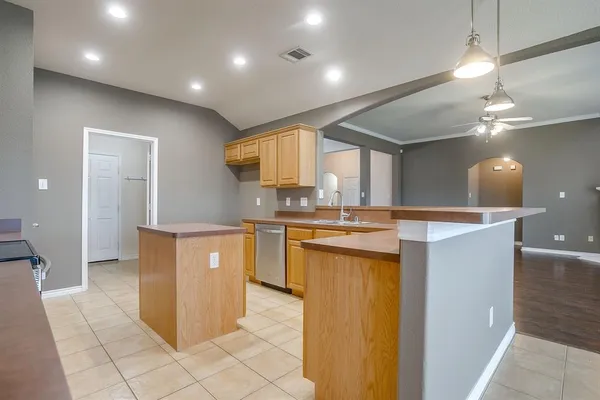 a kitchen with stainless steel appliances granite countertop a sink and a stove