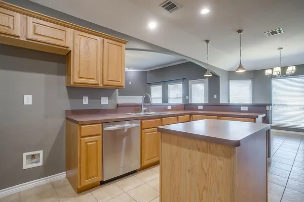 a kitchen with stainless steel appliances granite countertop a sink a stove and a refrigerator