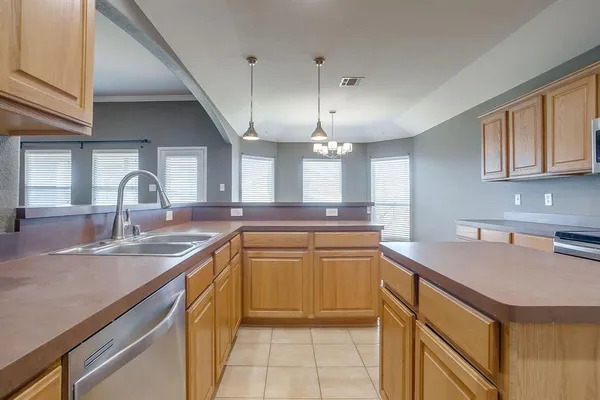 a kitchen with stainless steel appliances granite countertop a sink a stove and a wooden floors