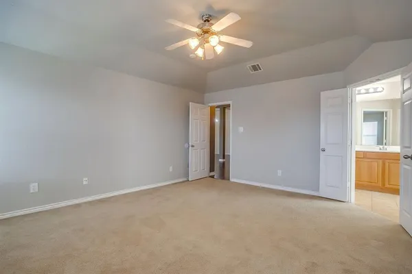 a view of an empty room with a ceiling fan