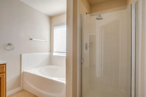 a bathroom with a bathtub and a shower