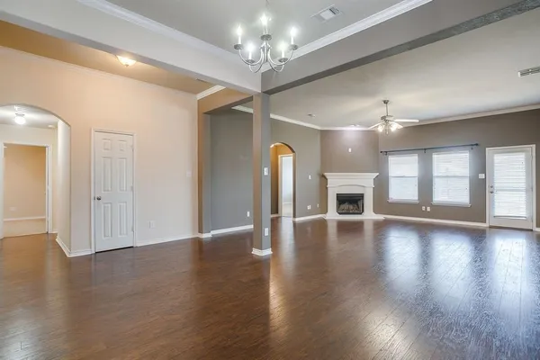a view of a room with wooden floor and chandelier