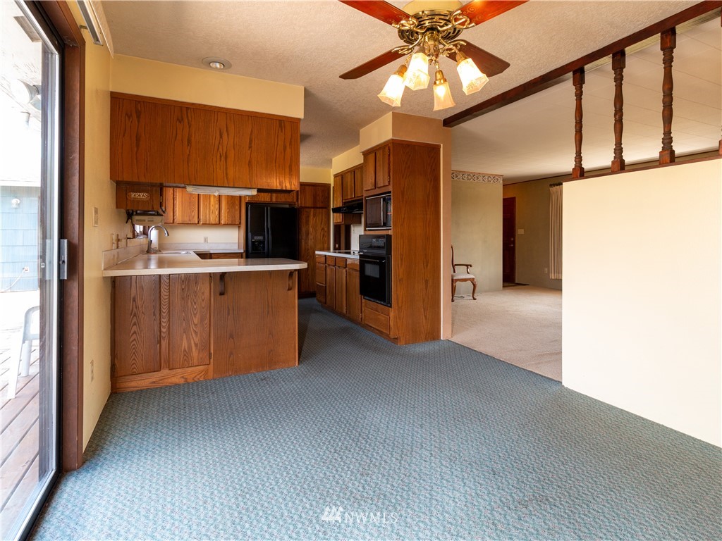 659 Spencer Road Toledo, WA 98591 - Photo 7 of 25 a kitchen with stainless steel appliances a refrigerator and a ceiling fan