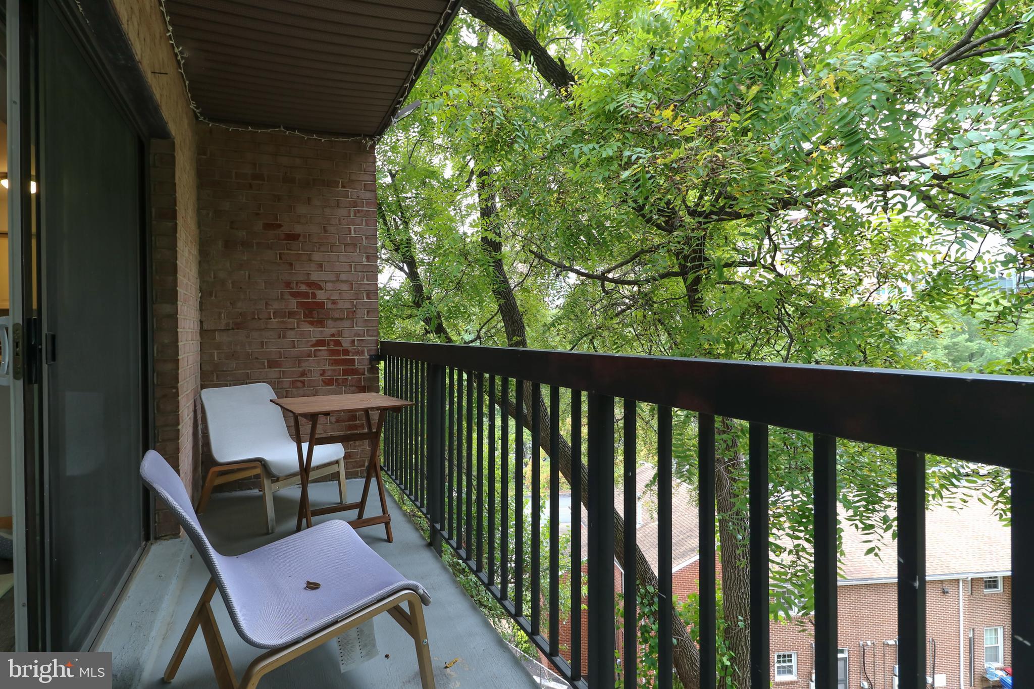 3210 South 28th Street, Unit 404 Alexandria, VA 22302 - Photo 12 of 25 a view of a balcony with chair and wooden floor