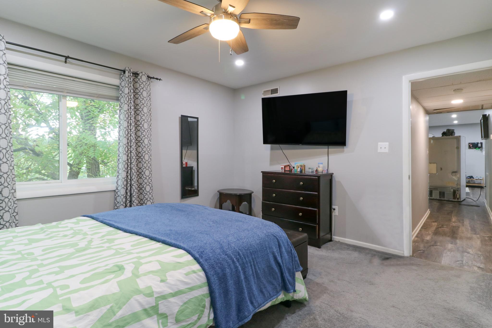 3210 South 28th Street, Unit 404 Alexandria, VA 22302 - Photo 13 of 25 a bedroom with a bed and a flat screen tv