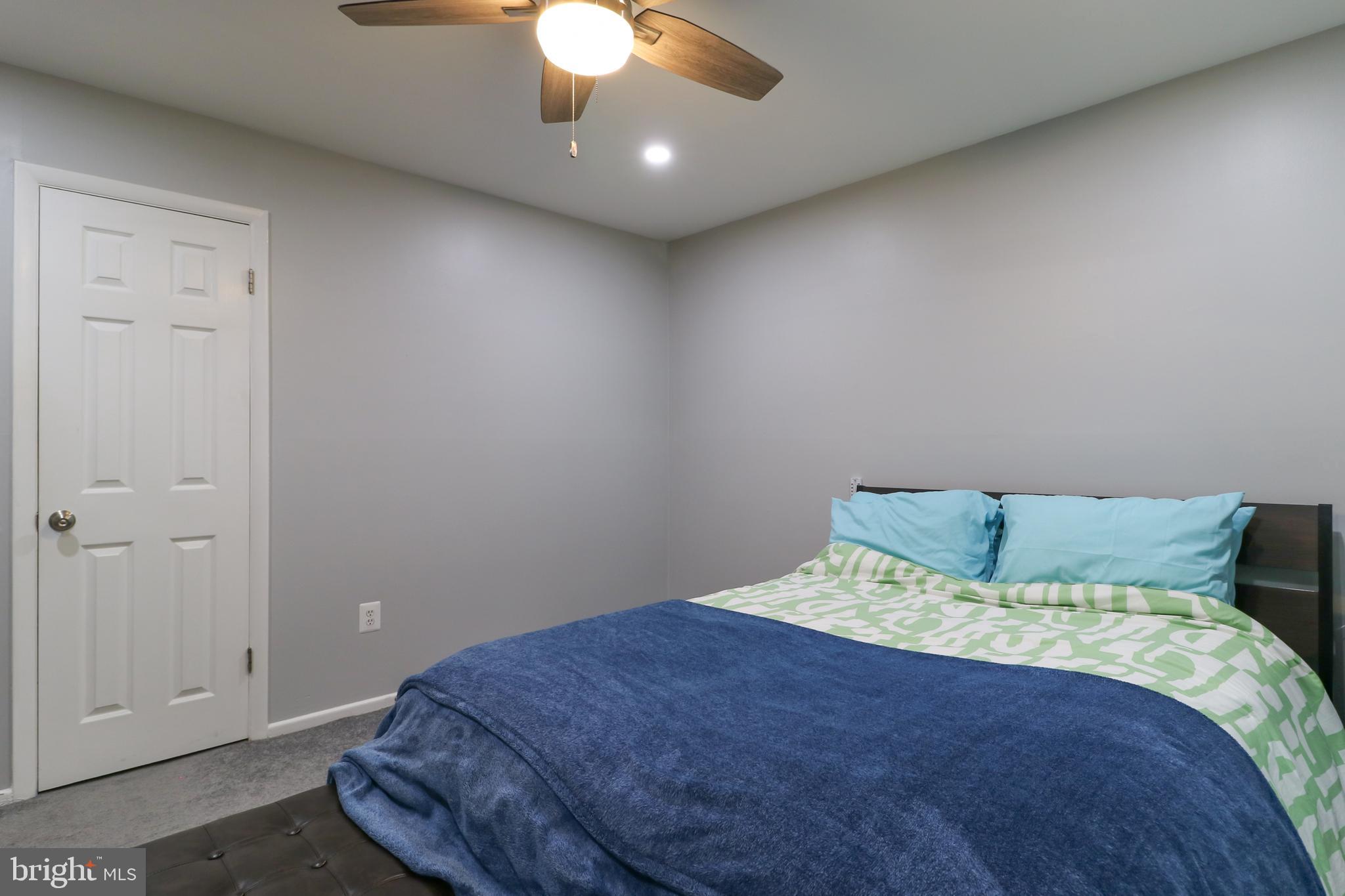 3210 South 28th Street, Unit 404 Alexandria, VA 22302 - Photo 15 of 25 a bedroom with a bed and lamp