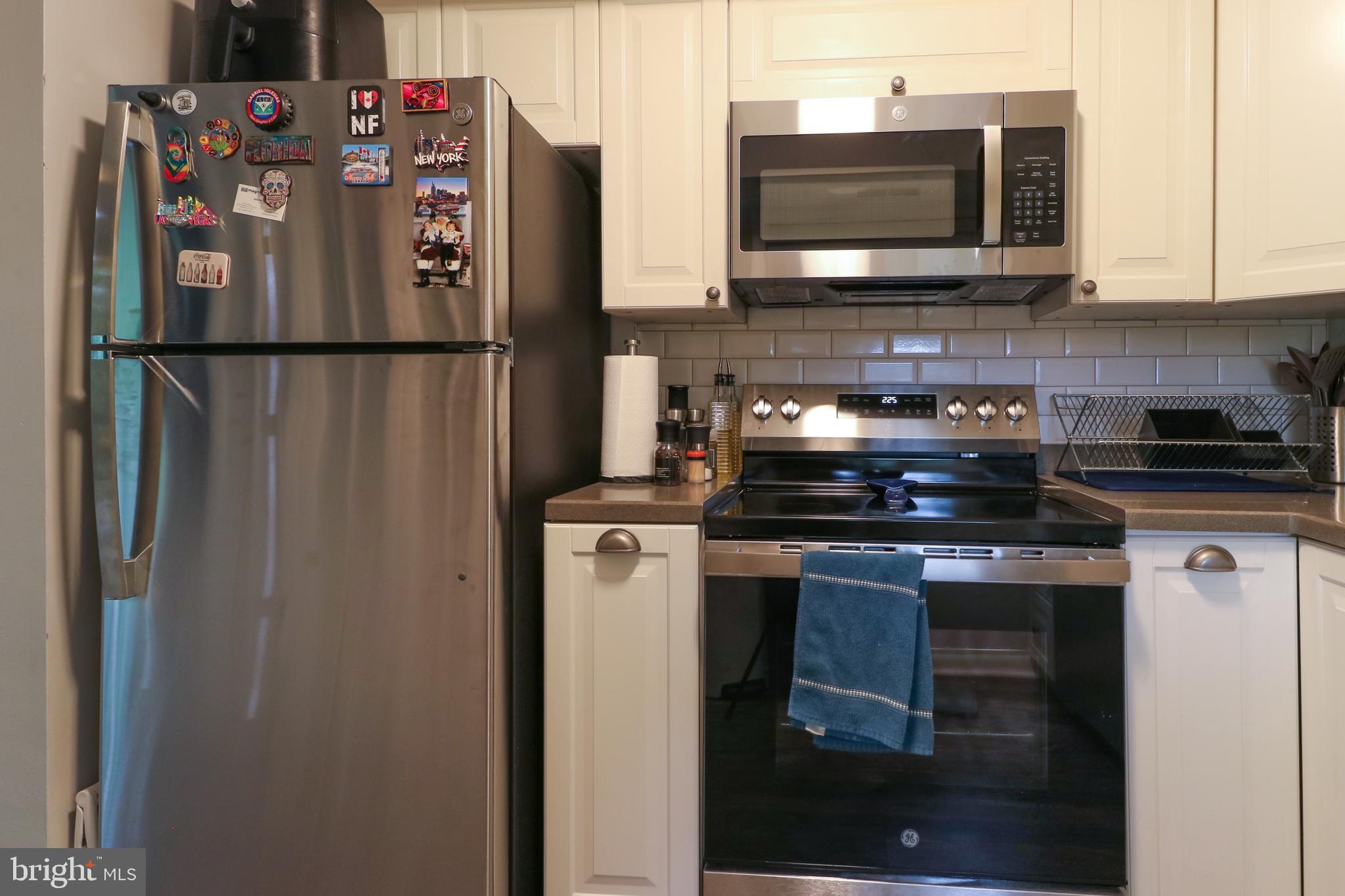 3210 South 28th Street, Unit 404 Alexandria, VA 22302 - Photo 4 of 25 a kitchen with stainless steel appliances granite countertop a refrigerator and a microwave