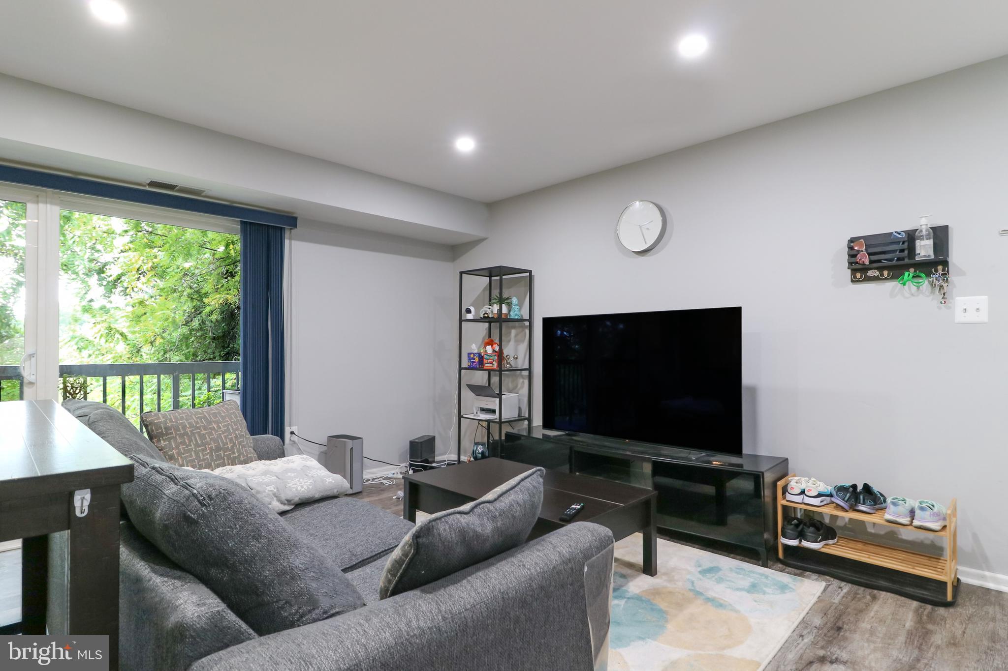 3210 South 28th Street, Unit 404 Alexandria, VA 22302 - Photo 6 of 25 a living room with furniture and a flat screen tv