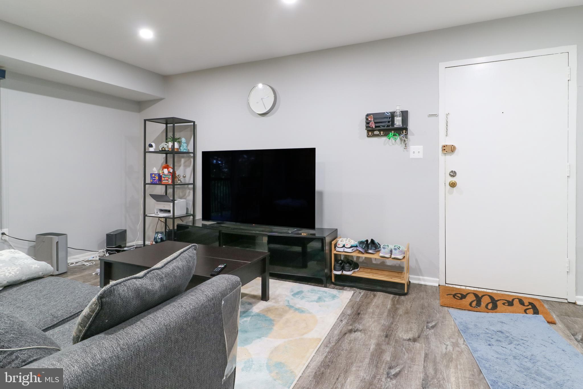 3210 South 28th Street, Unit 404 Alexandria, VA 22302 - Photo 7 of 25 a living room with furniture and a flat screen tv