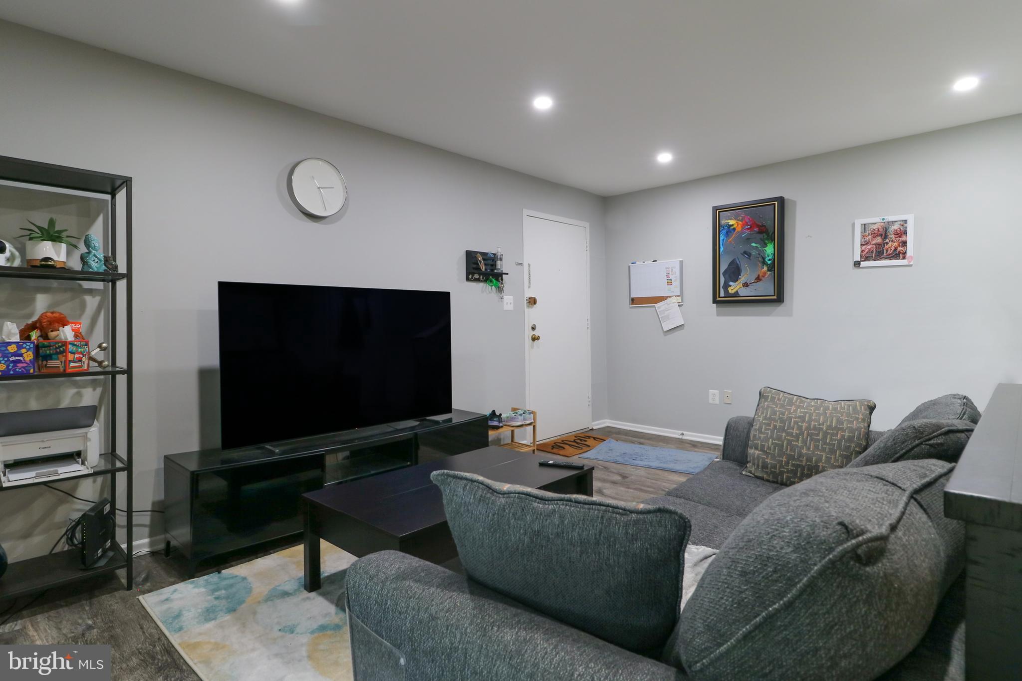 3210 South 28th Street, Unit 404 Alexandria, VA 22302 - Photo 8 of 25 a living room with furniture and a flat screen tv