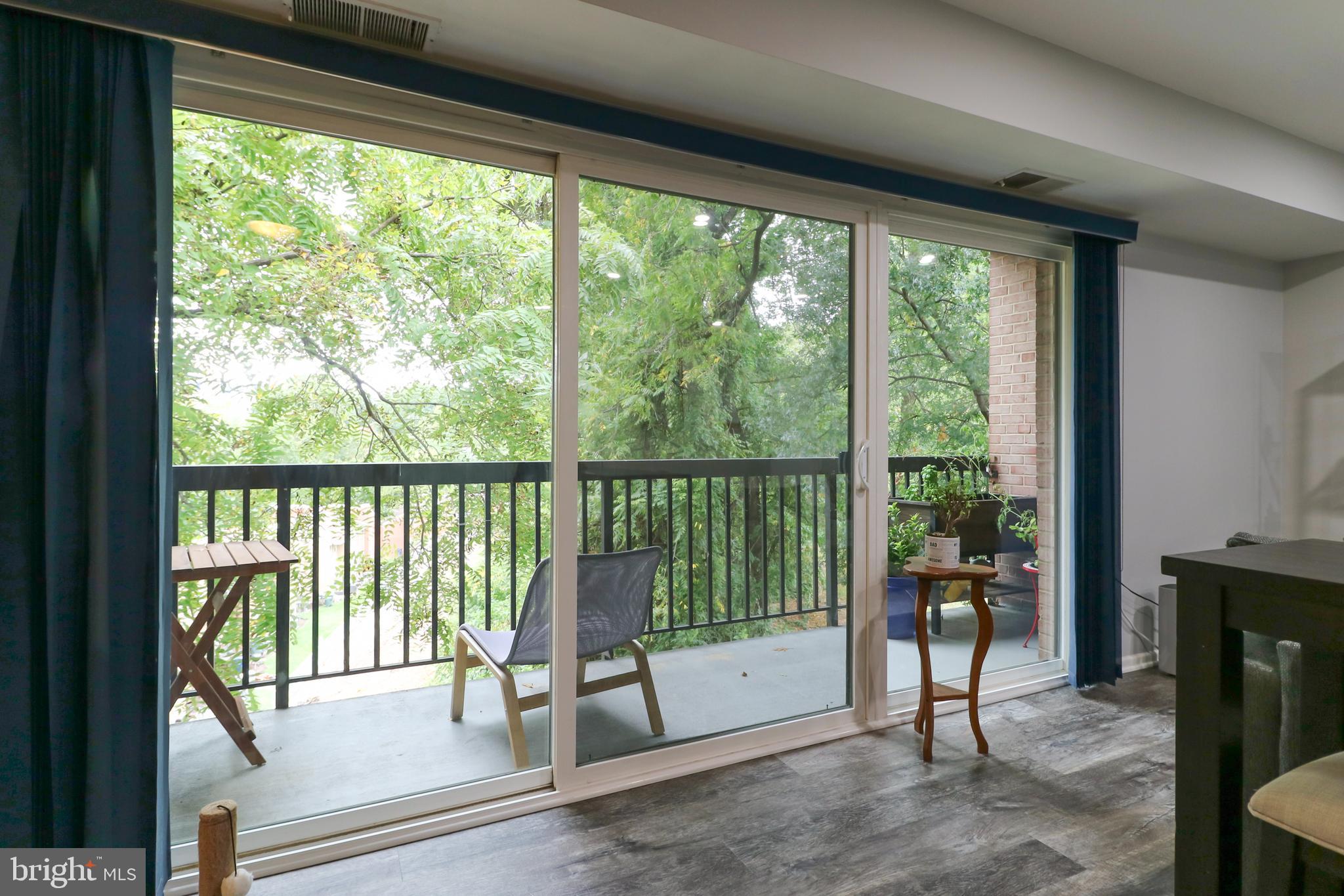 3210 South 28th Street, Unit 404 Alexandria, VA 22302 - Photo 10 of 25 a view of a room with wooden floor and windows