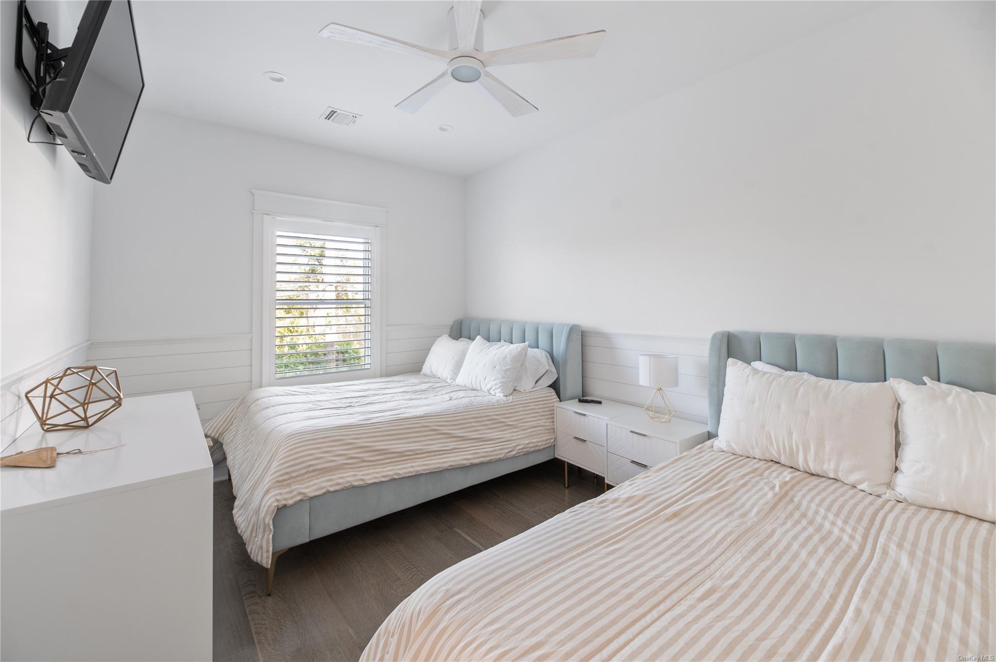 335 Surf Road Ocean Beach, NY 11770 - Photo 4 of 12 a bedroom with two beds and a chandelier