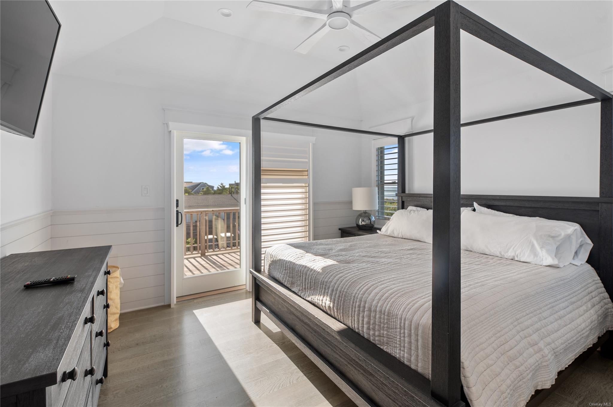 335 Surf Road Ocean Beach, NY 11770 - Photo 7 of 12 a bedroom with a large bed and a window