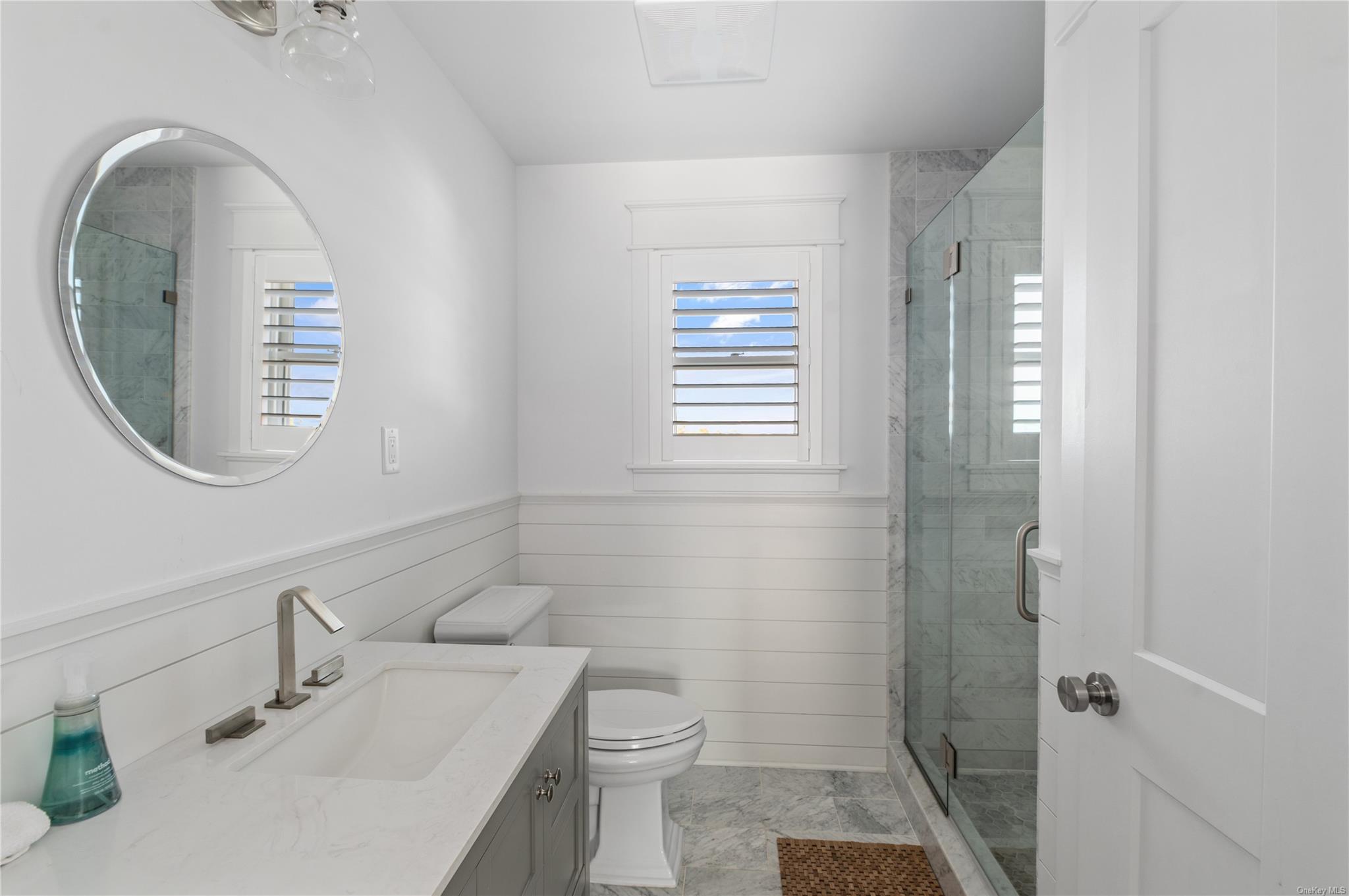 335 Surf Road Ocean Beach, NY 11770 - Photo 8 of 12 a bathroom with a sink a toilet and a mirror