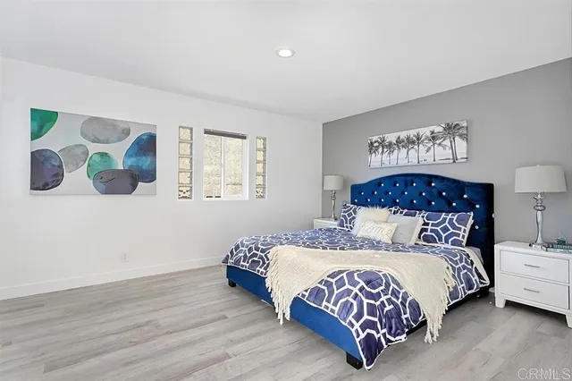 a bedroom with a bed lamp and a window