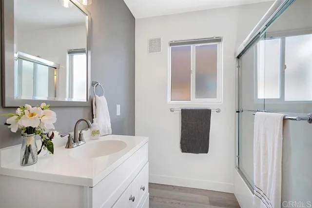 a bathroom with a sink vanity and a mirror
