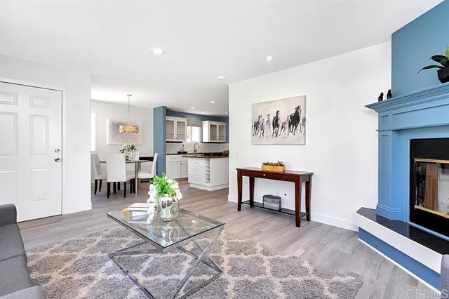 a living room with furniture a table and a fireplace