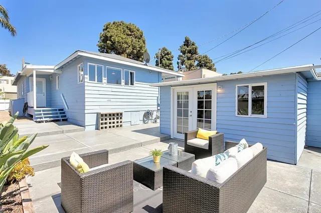 a front view of a house with outdoor seating