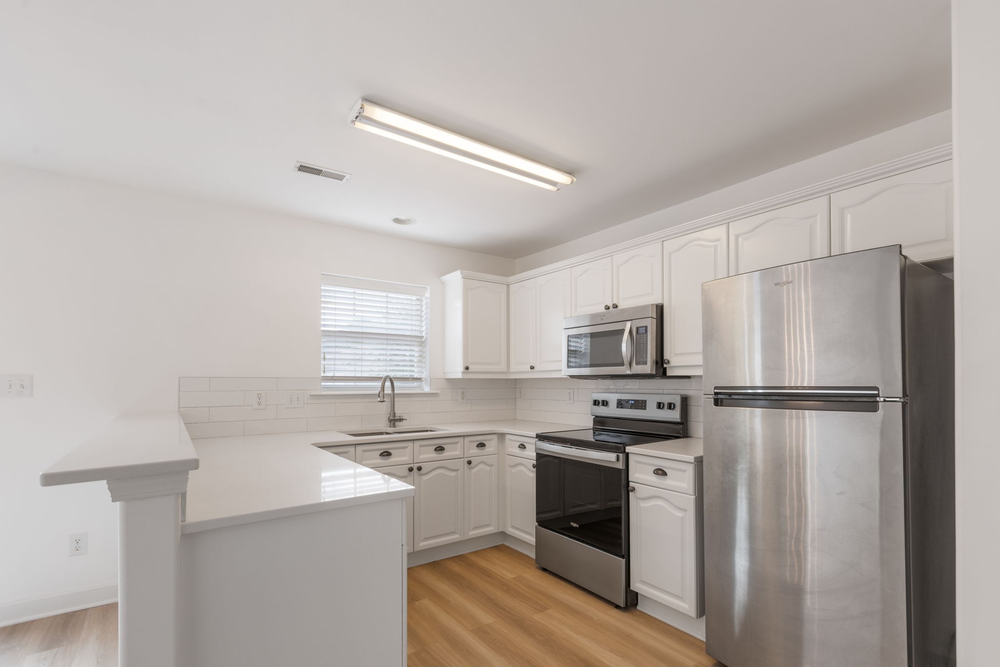 2505 Preston Way Spring Hill, TN 37174 - Photo 12 of 37 a kitchen with refrigerator a sink and white cabinets