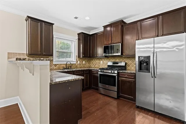 a kitchen with a refrigerator stove and sink