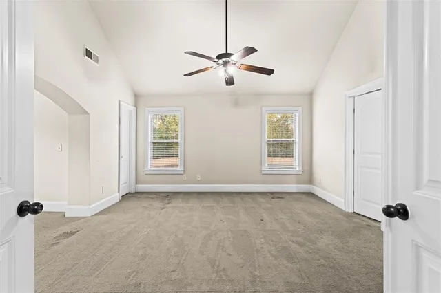 a view of a livingroom with a ceiling fan and window