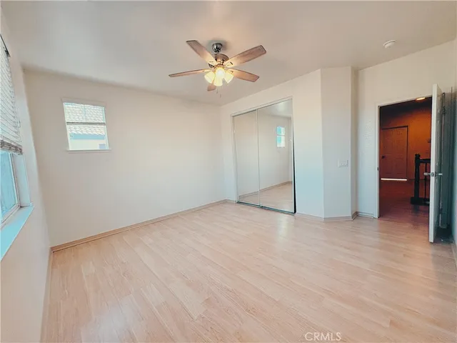 a view of an empty room with a ceiling fan