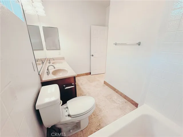 a white toilet sitting next to a shower