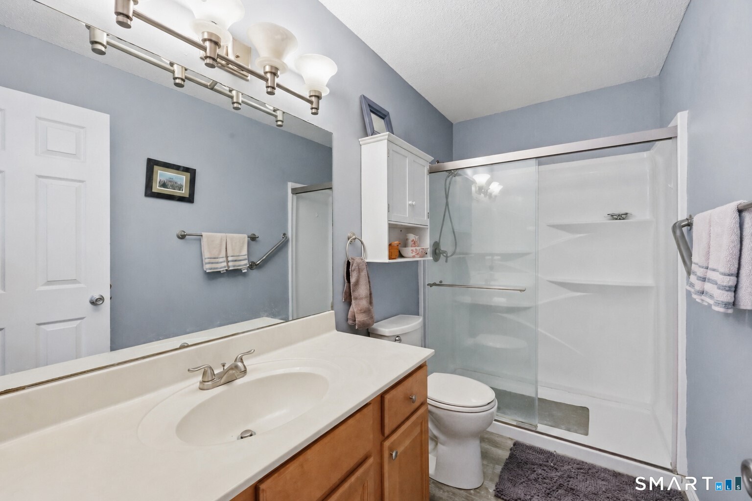 2 Rivermead, Unit 2 Avon, CT 06001 - Photo 19 of 36 a bathroom with a shower sink vanity mirror and toilet
