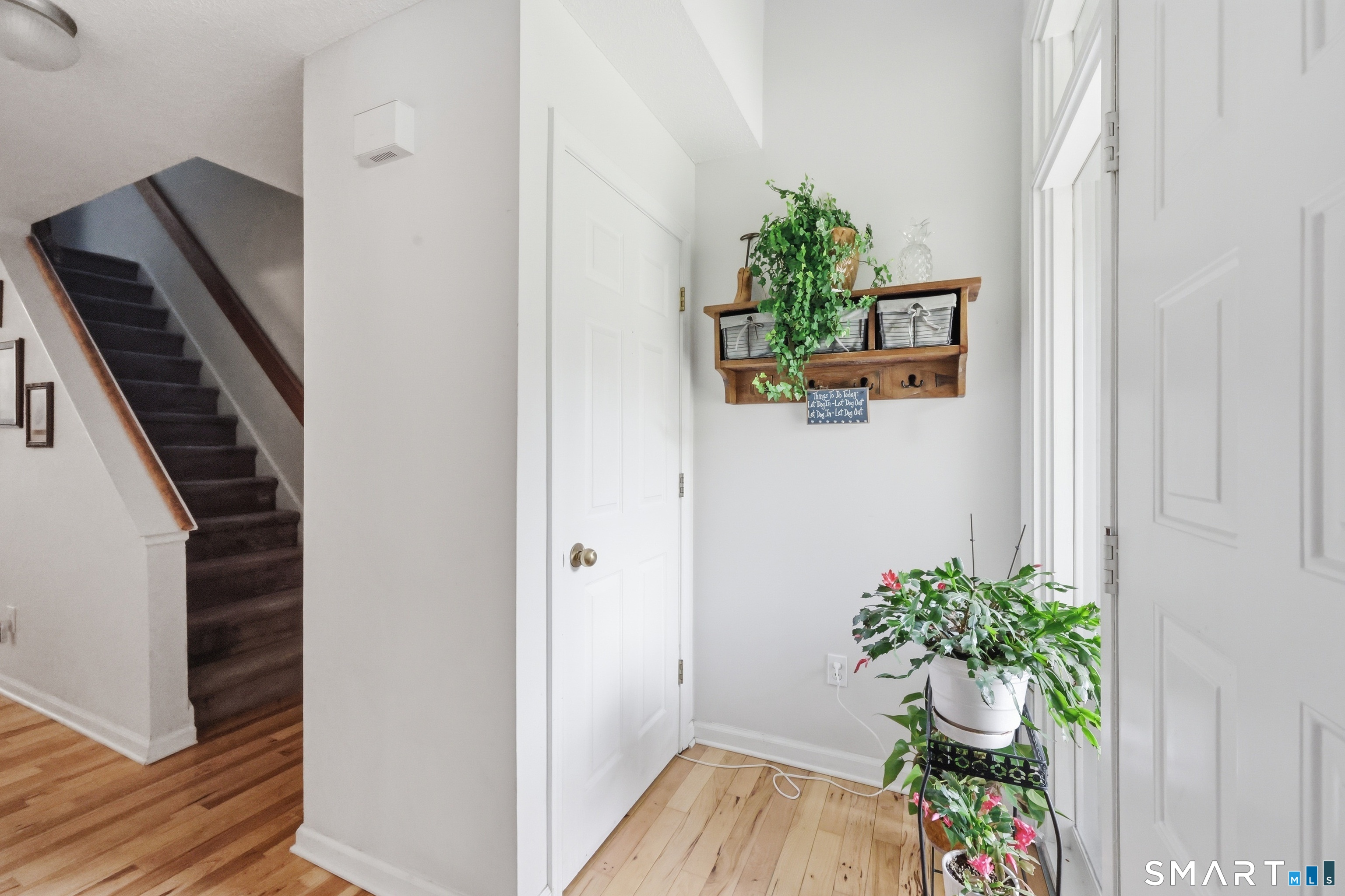 2 Rivermead, Unit 2 Avon, CT 06001 - Photo 4 of 36 a view of a hallway with wooden floor and a potted plant