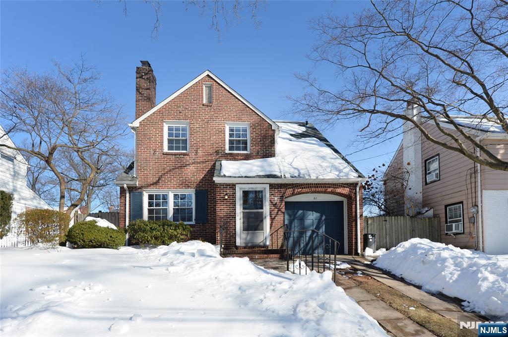 87 Grayson Place Teaneck, NJ 07666 - Photo 1 of 20 a front view of a house with a yard