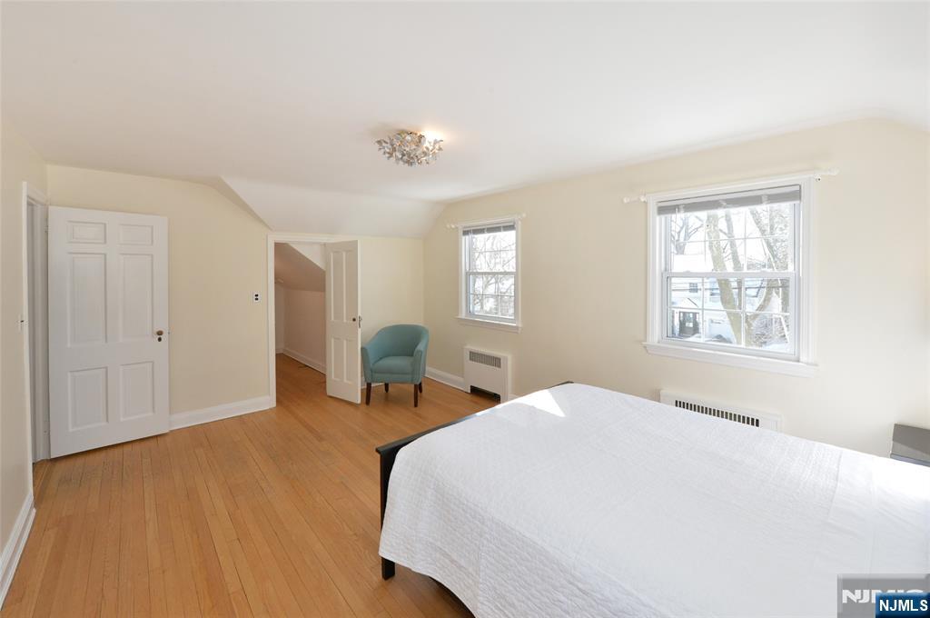 87 Grayson Place Teaneck, NJ 07666 - Photo 11 of 20 a bedroom with a bed and window