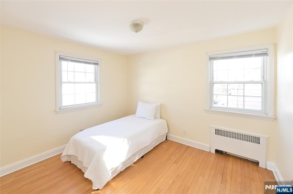87 Grayson Place Teaneck, NJ 07666 - Photo 13 of 20 a bedroom with a bed and a window