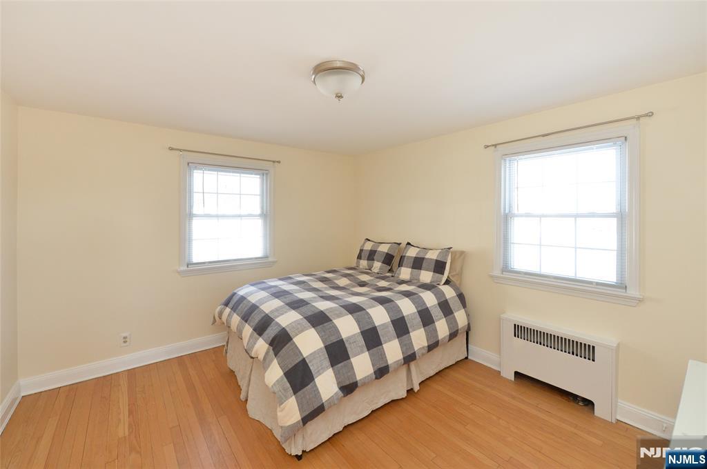 87 Grayson Place Teaneck, NJ 07666 - Photo 15 of 20 a bedroom with a bed and a window