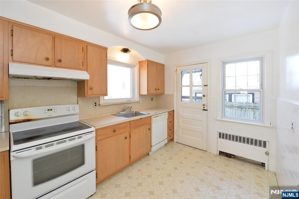 87 Grayson Place Teaneck, NJ 07666 - Photo 5 of 20 a kitchen with cabinets and window
