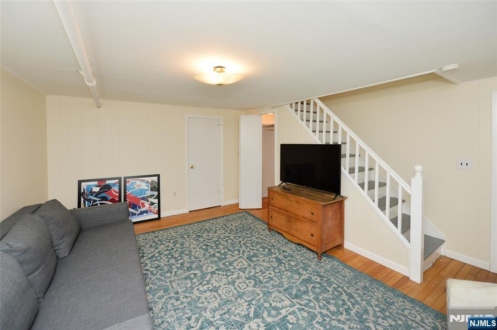 87 Grayson Place Teaneck, NJ 07666 - Photo 8 of 20 a living room with furniture and a flat screen tv