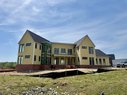 a front view of a house with a yard table and chairs