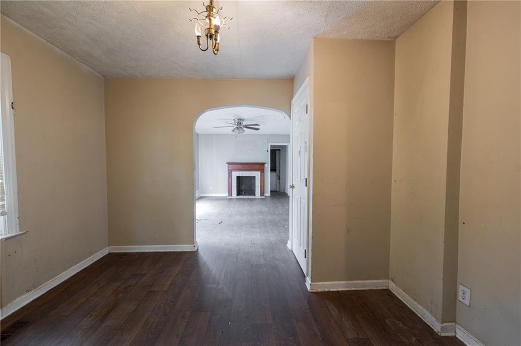 3838 Old Gordon Road Northwest Atlanta, GA 30336 - Photo 7 of 23 a view of a hallway to an empty room with wooden floor and a window