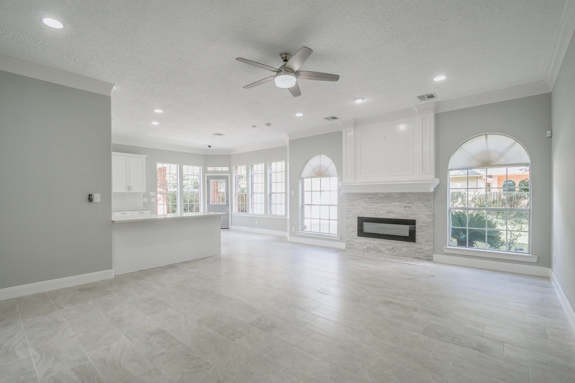 6302 Laver Love Drive Spring, TX 77379 - Photo 12 of 38 a view of an empty room with a fireplace and a window