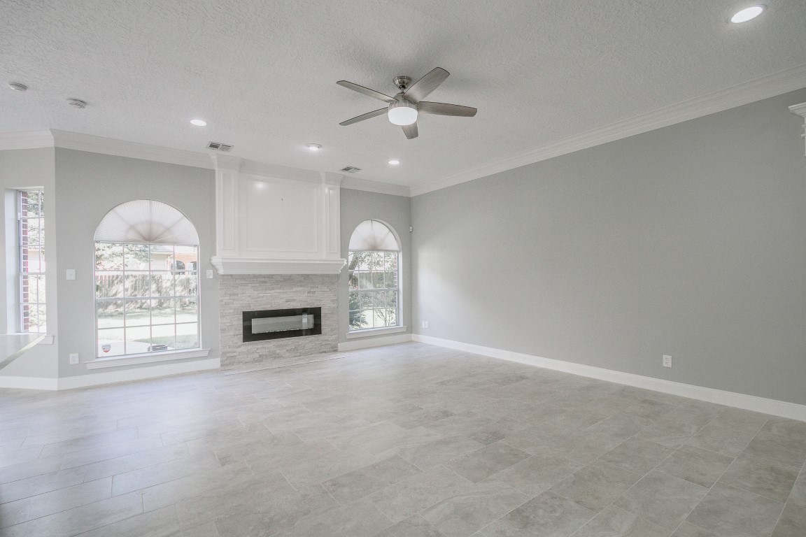 6302 Laver Love Drive Spring, TX 77379 - Photo 13 of 38 an empty room with windows and fireplace