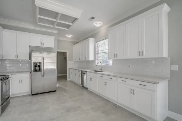 a kitchen with white cabinets