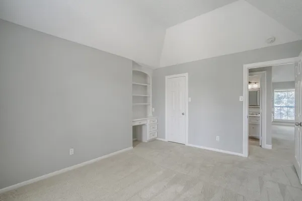 a view of an empty room and closet area