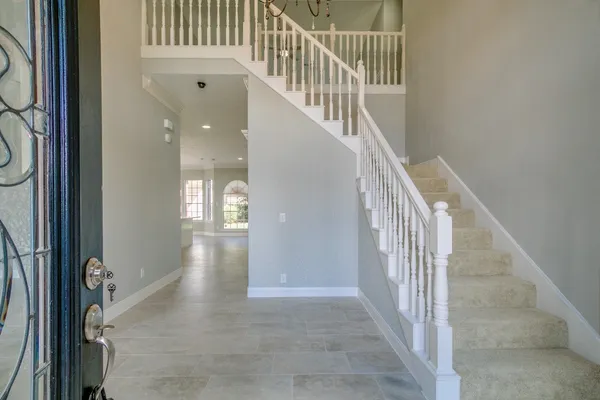 a view of entryway and hall with wooden floor