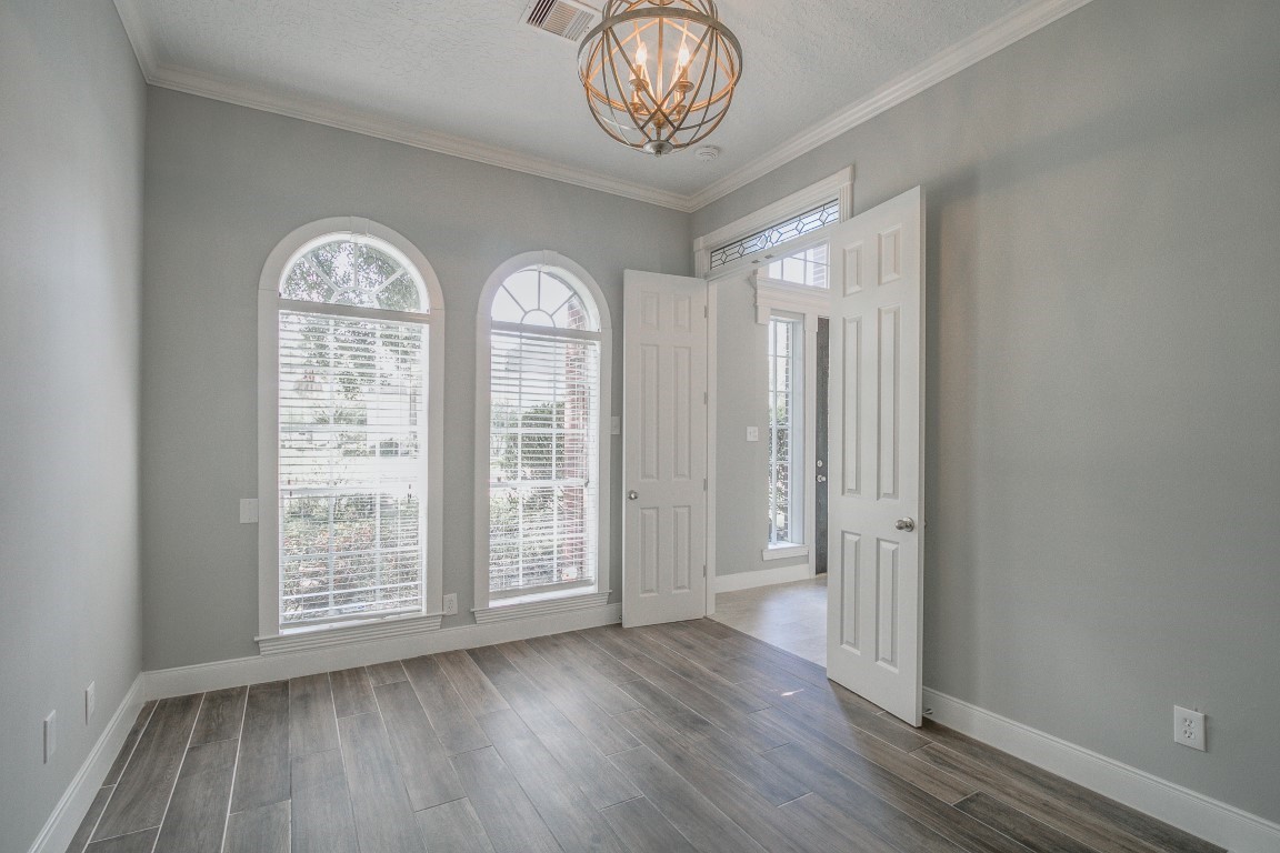 6302 Laver Love Drive Spring, TX 77379 - Photo 5 of 38 an empty room with wooden floor fan and windows