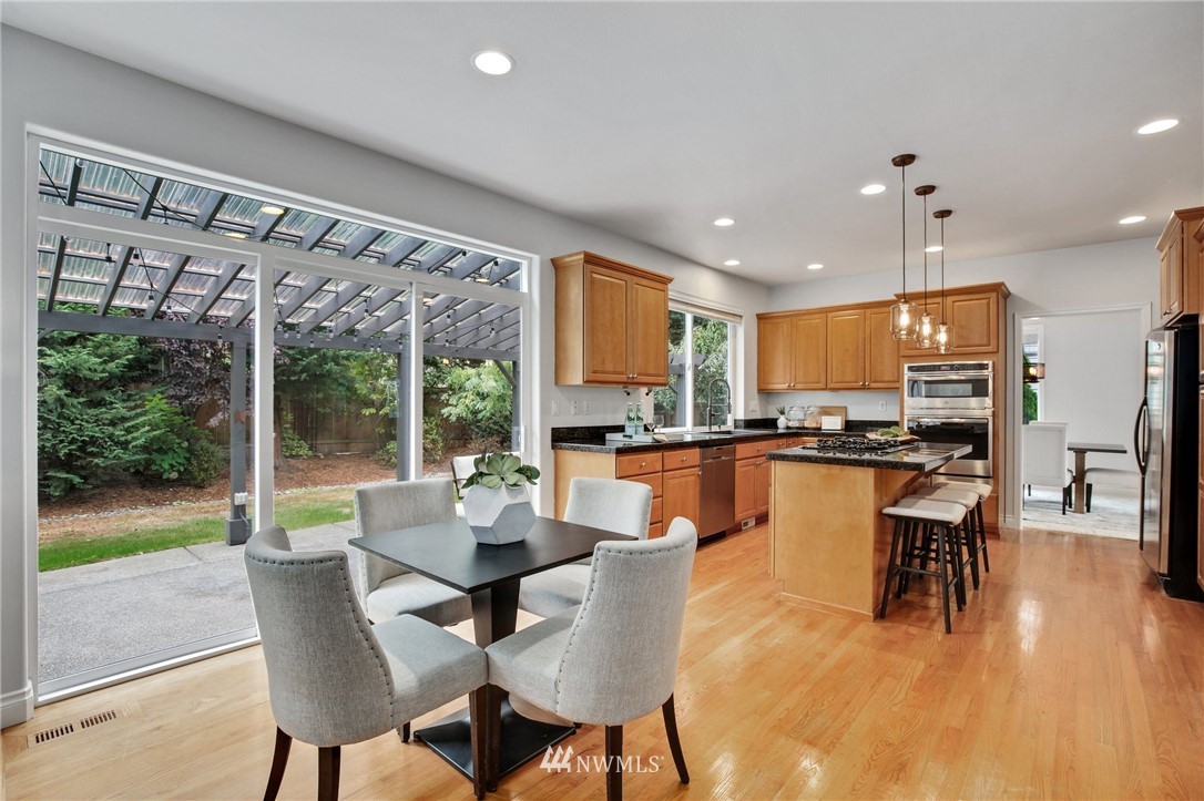 17264 Southeast 185th Street Renton, WA 98058 - Photo 11 of 40 a dining room with furniture water view and large windows
