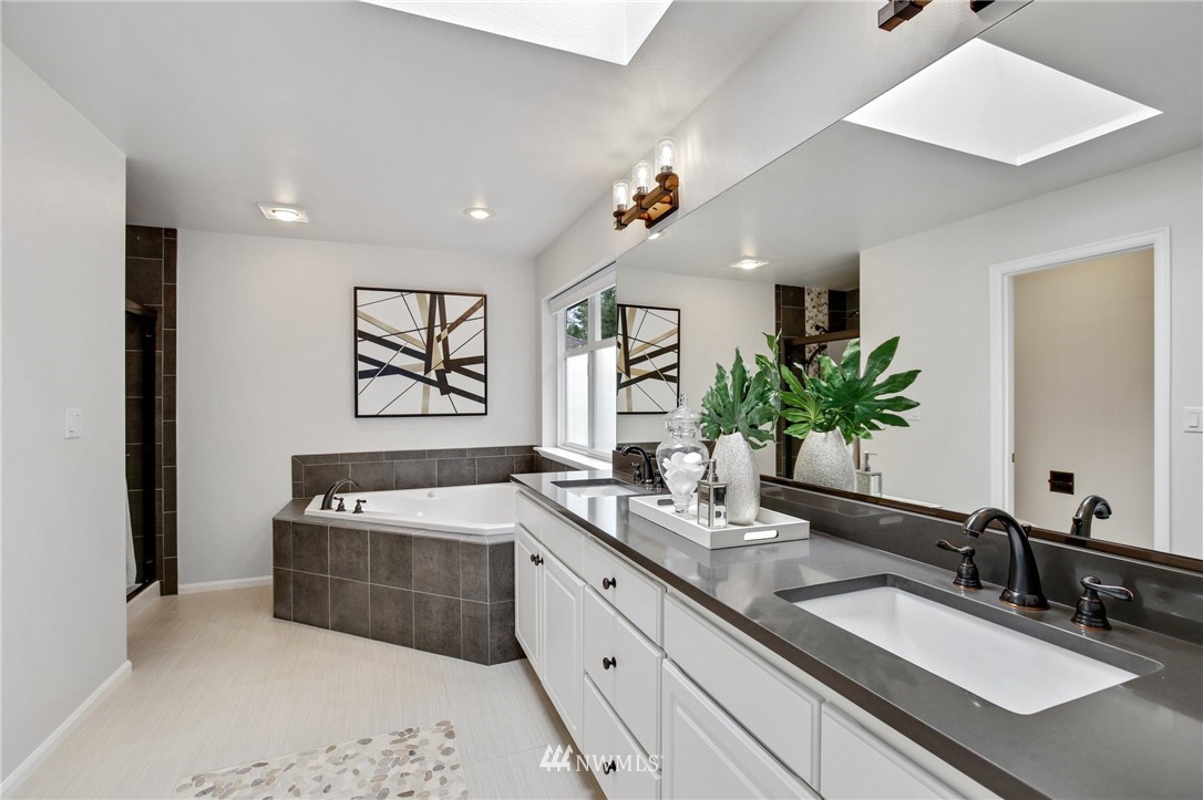 17264 Southeast 185th Street Renton, WA 98058 - Photo 29 of 40 a spacious bathroom with a tub sink and mirror