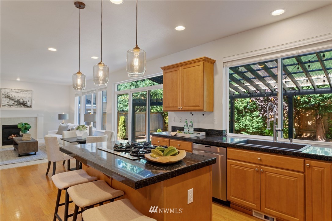 17264 Southeast 185th Street Renton, WA 98058 - Photo 10 of 40 a kitchen with large windows and refrigerator