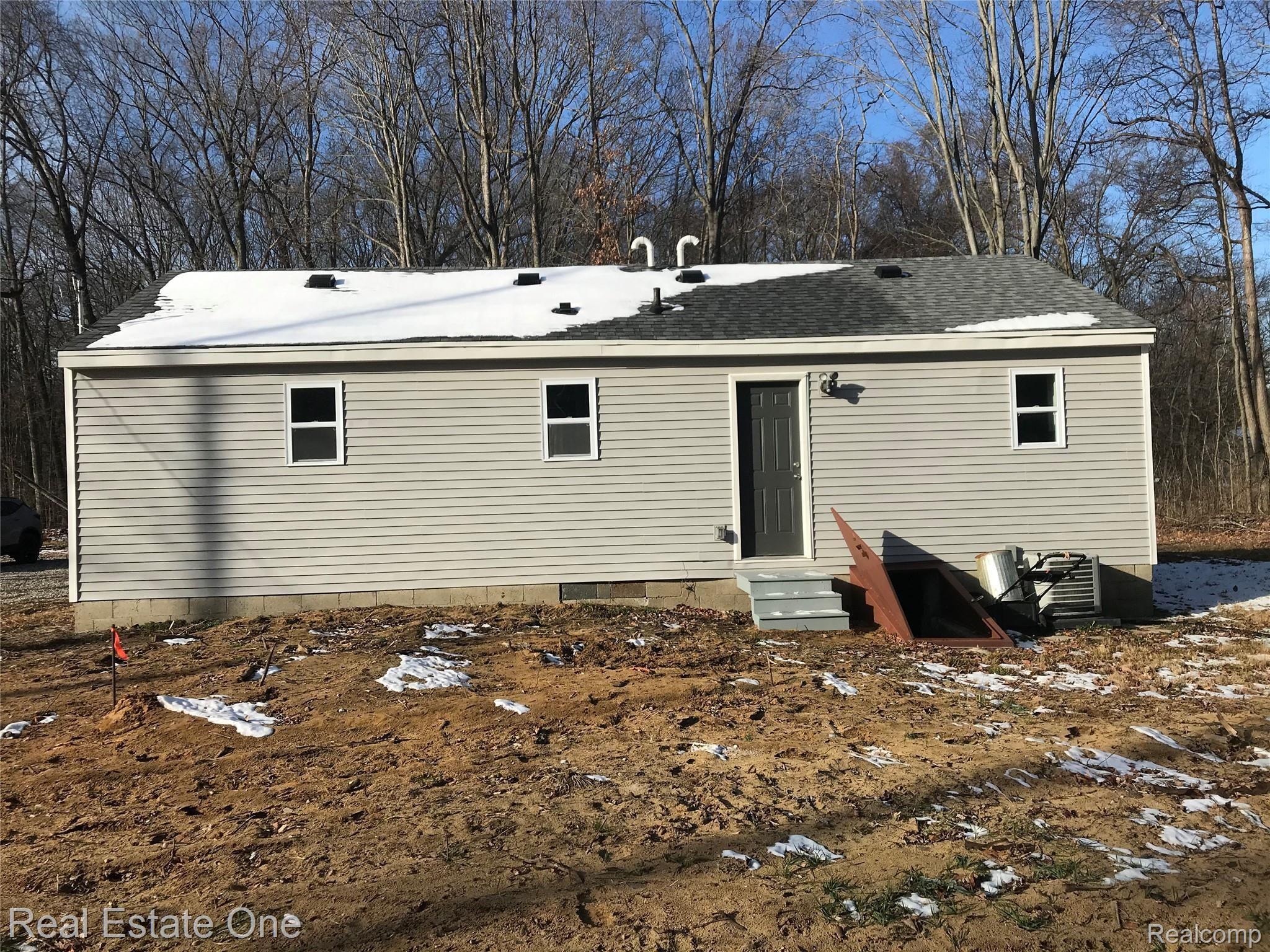 21251 Haggerty Road Belleville, MI 48111 - Photo 18 of 19 Back of House - New vinyl siding, new roof. Ready for finishing touches